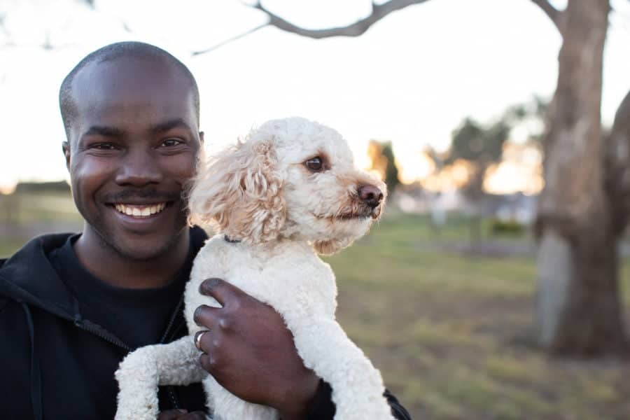 person with his holding his vegan dog