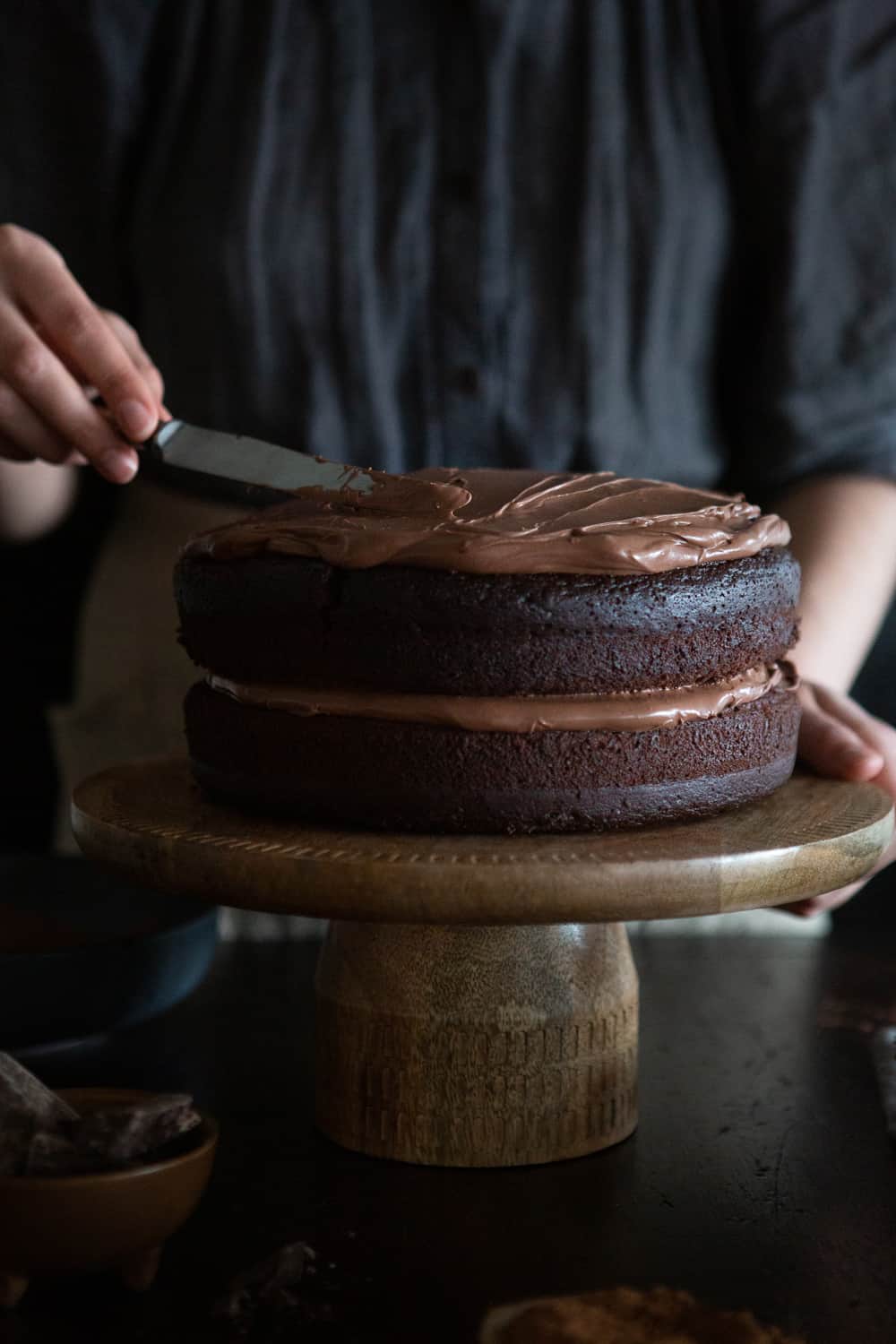 classic vegan chocolate cake applying ganache The Minimalist Vegan