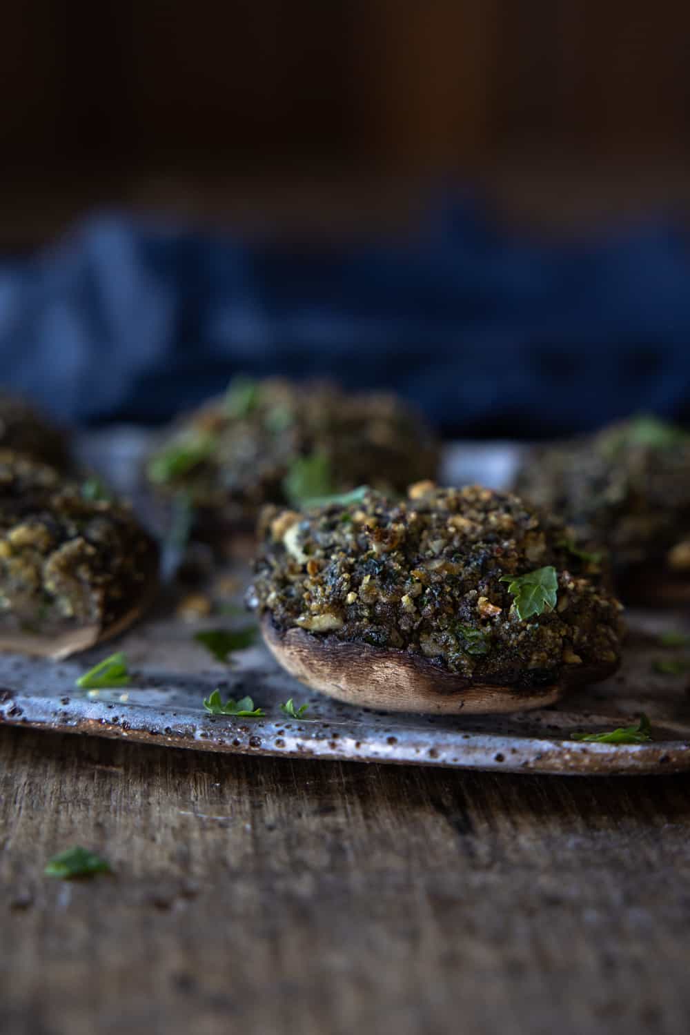 Close up of a baked stuffed mushroom on a plate.