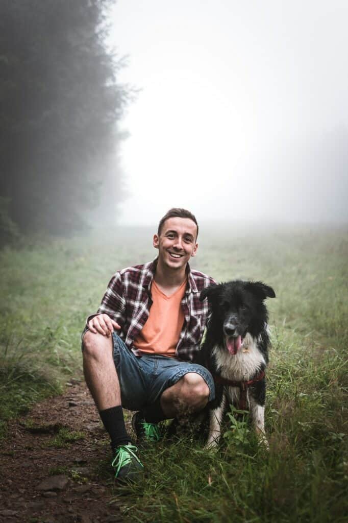 man sitting with dog