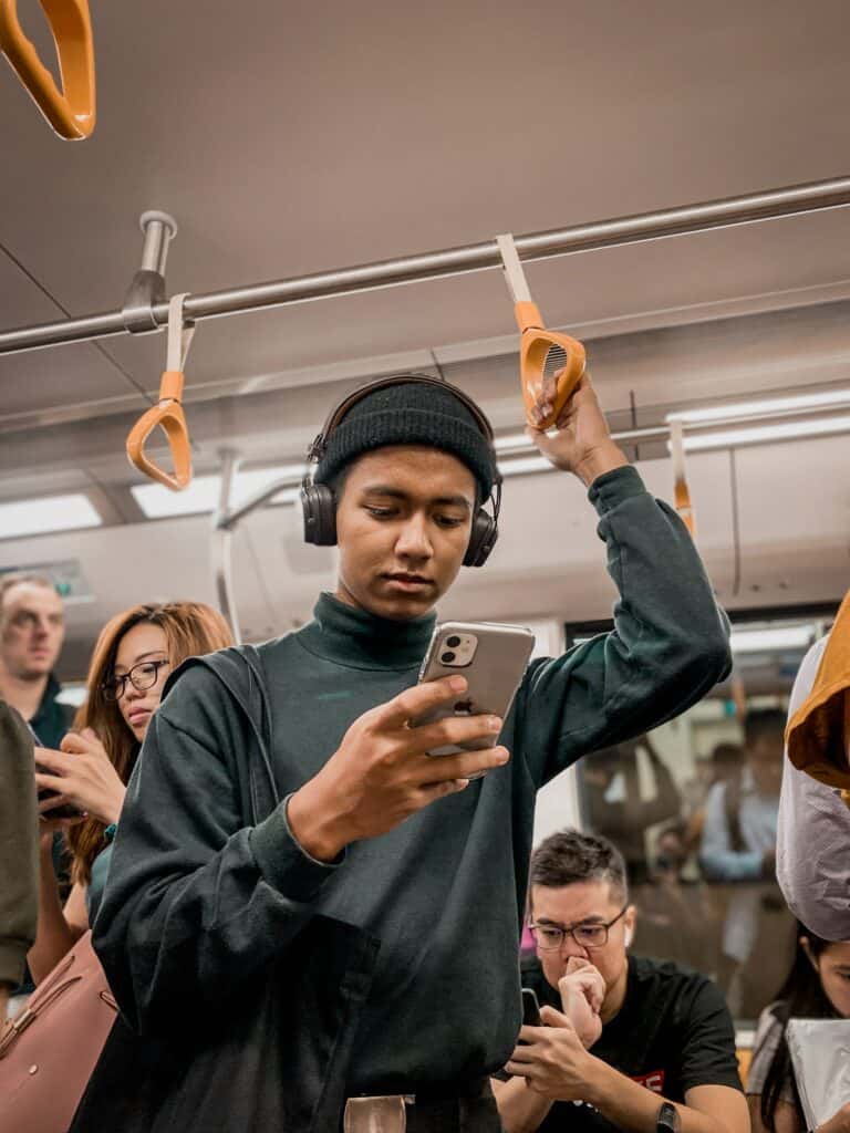 digital detox man holding phone on train