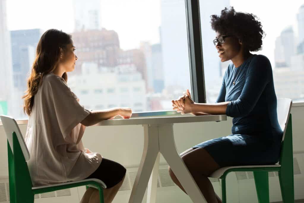 two women having a conversation about unwanted gifts